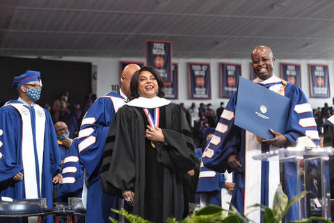 Taraji P. Henson and President Wayne A.I. Frederick on stage at Commencement 2022.